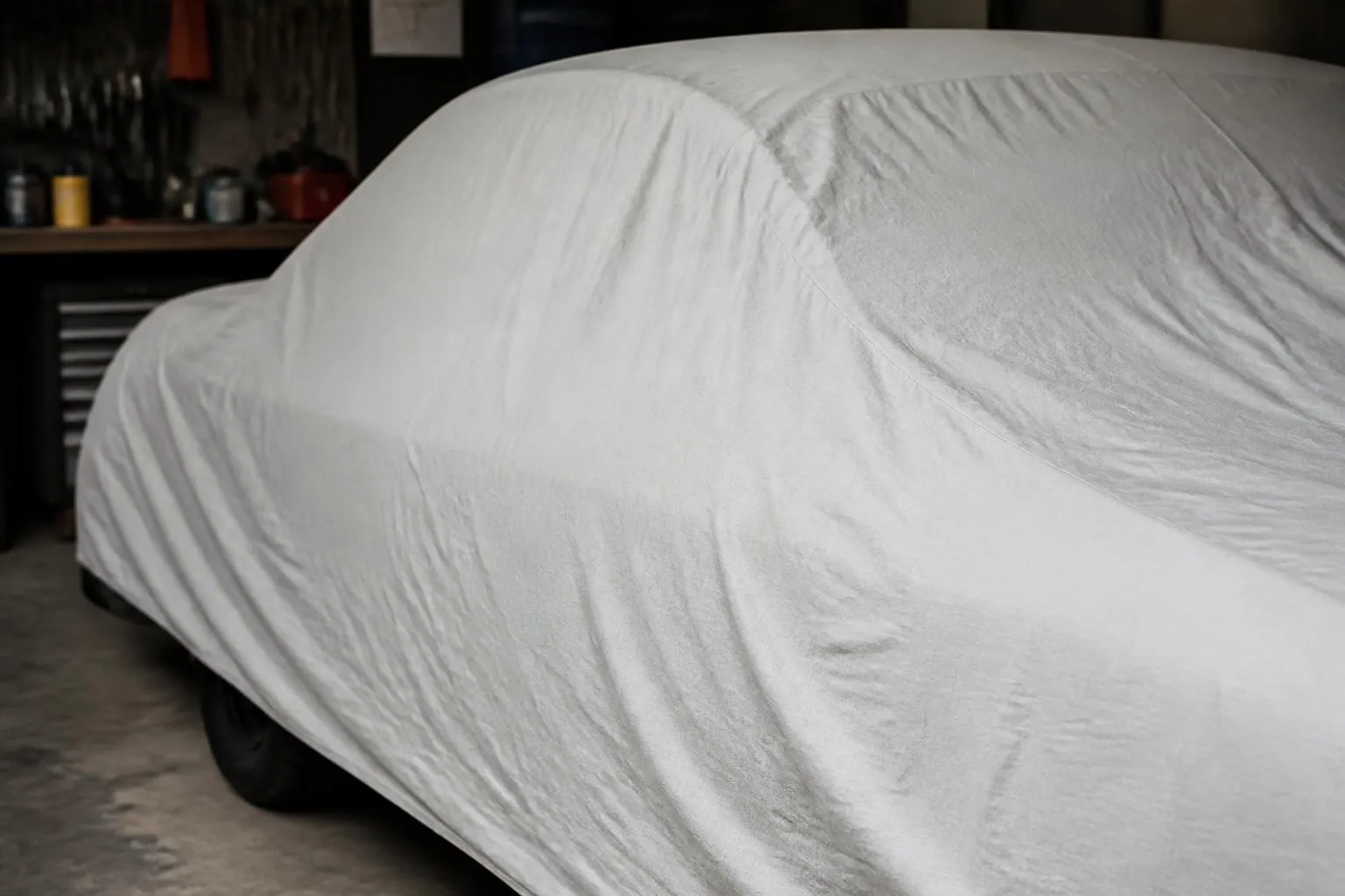 Housse de protection sur une voiture dans un garage